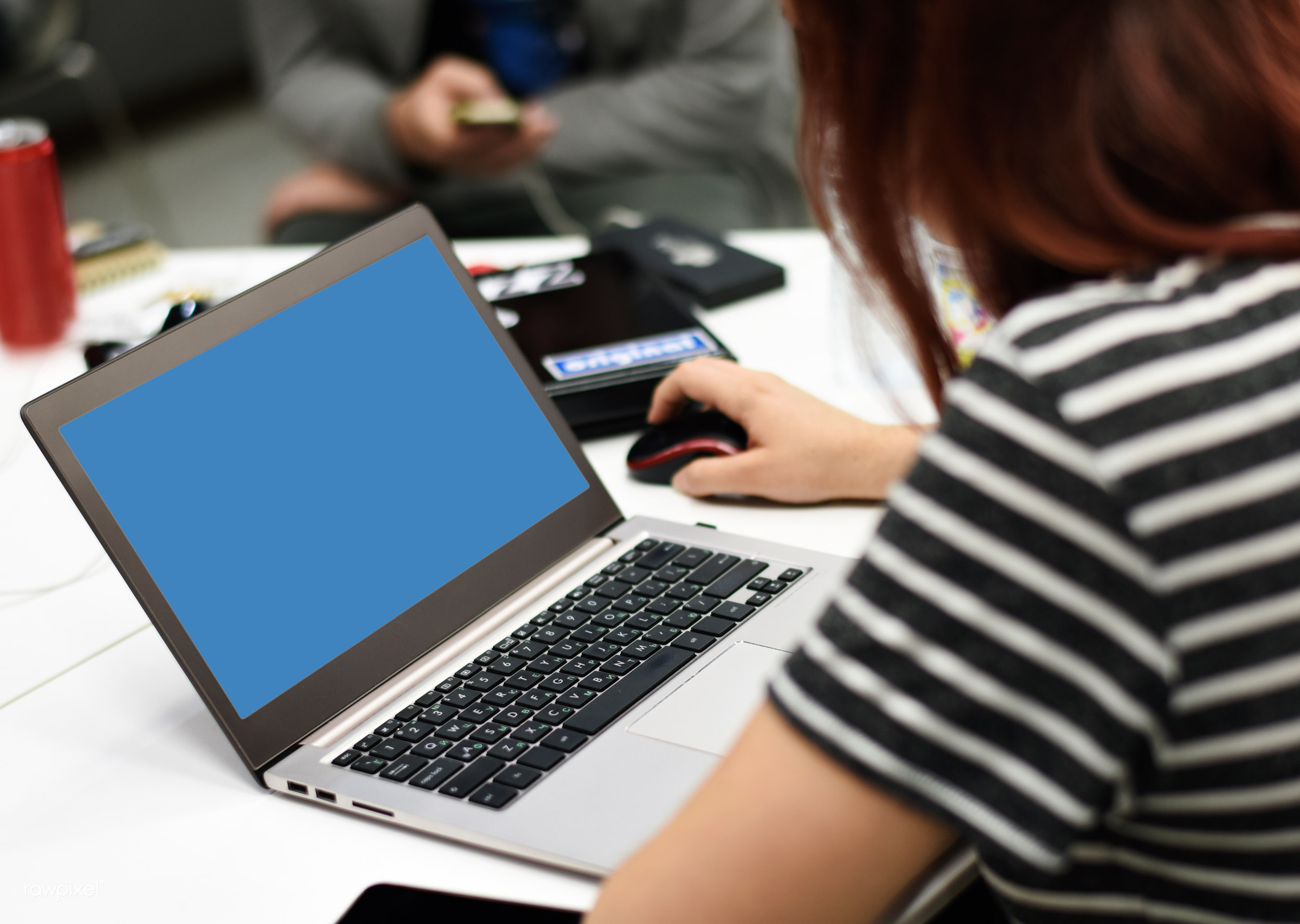 People working around a laptop, representing small business planning and the tradeoffs behind a marketing-site platform decision.